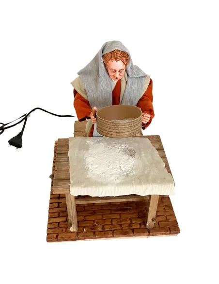 Donna che setaccia la farina palestinese 30 cm in movimento